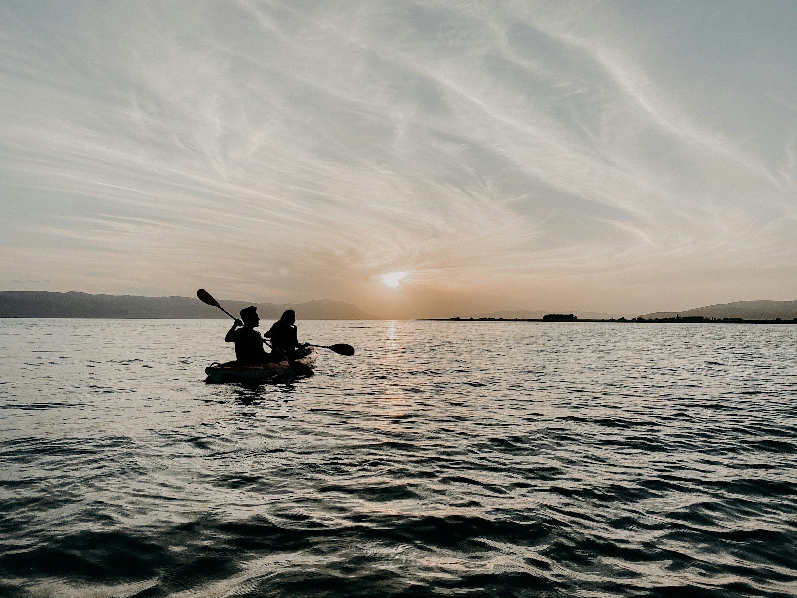 2 person riding on boat during daytime
