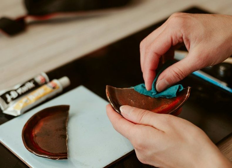 Repairing a broken ceramic bowl with glue and a cloth